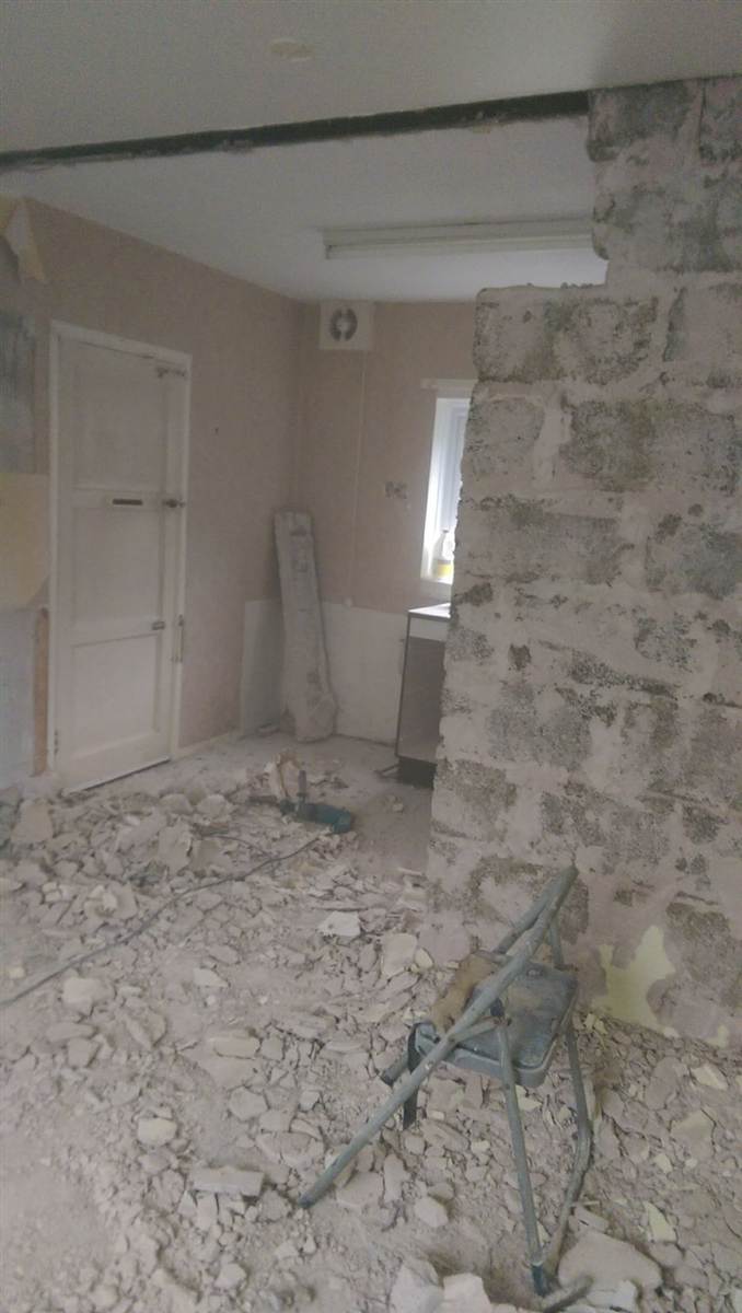 During — wall knocked through with RSJ installed in the ceiling, rubble cleared from the floor
